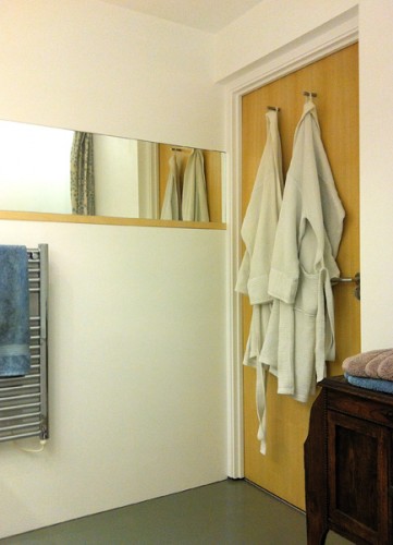 mirror set flush within wall panelling / no skirting / rubber flooring