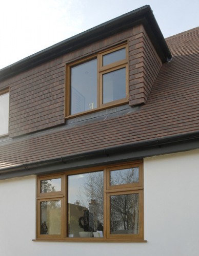 timber framed windows aligned / tile hung dormer face and cheeks to lessen visual impact